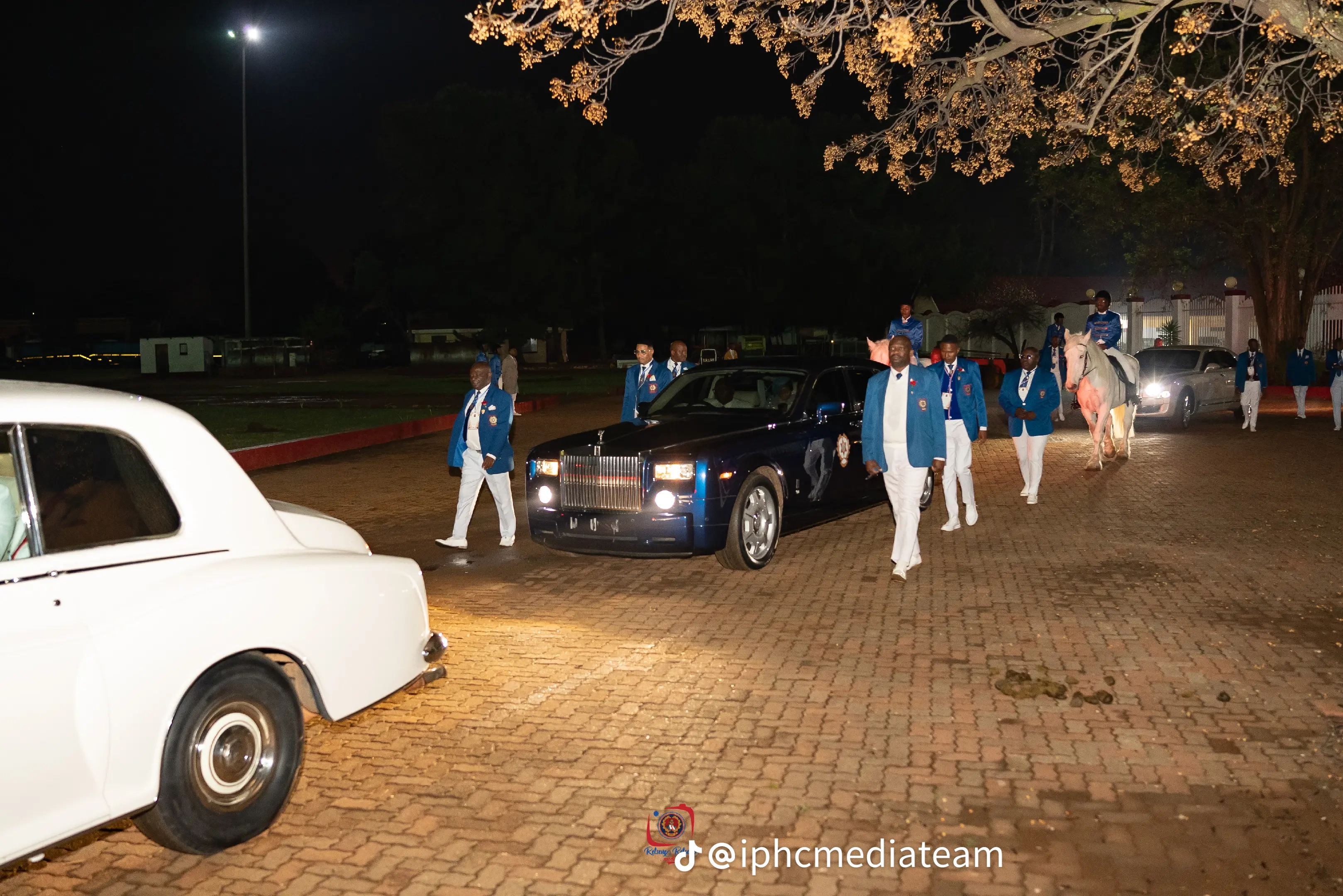 White and dark blue vehicles in the IPHC procession
