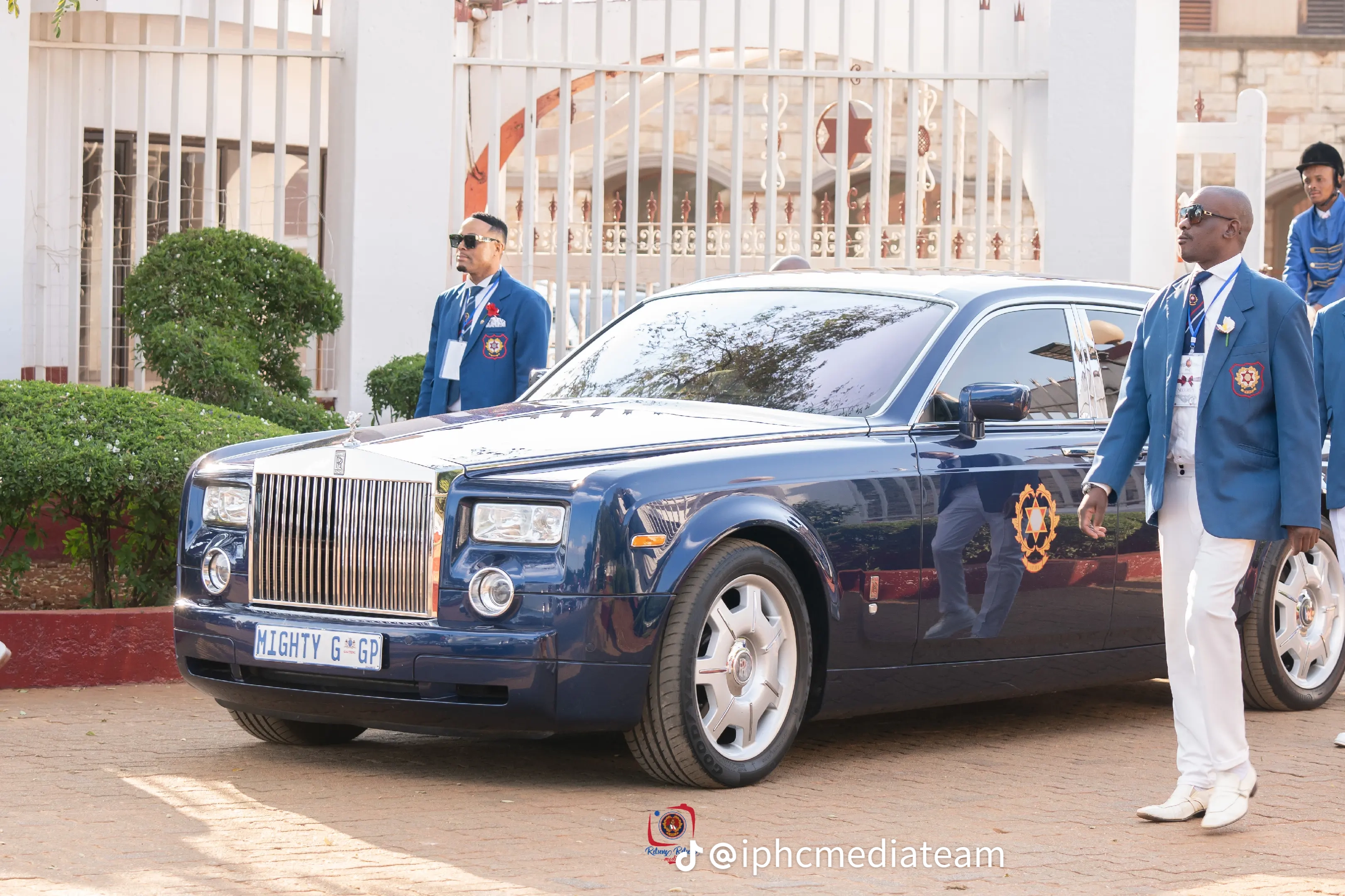 Dark blue IPHC vehicle photographed with attendants