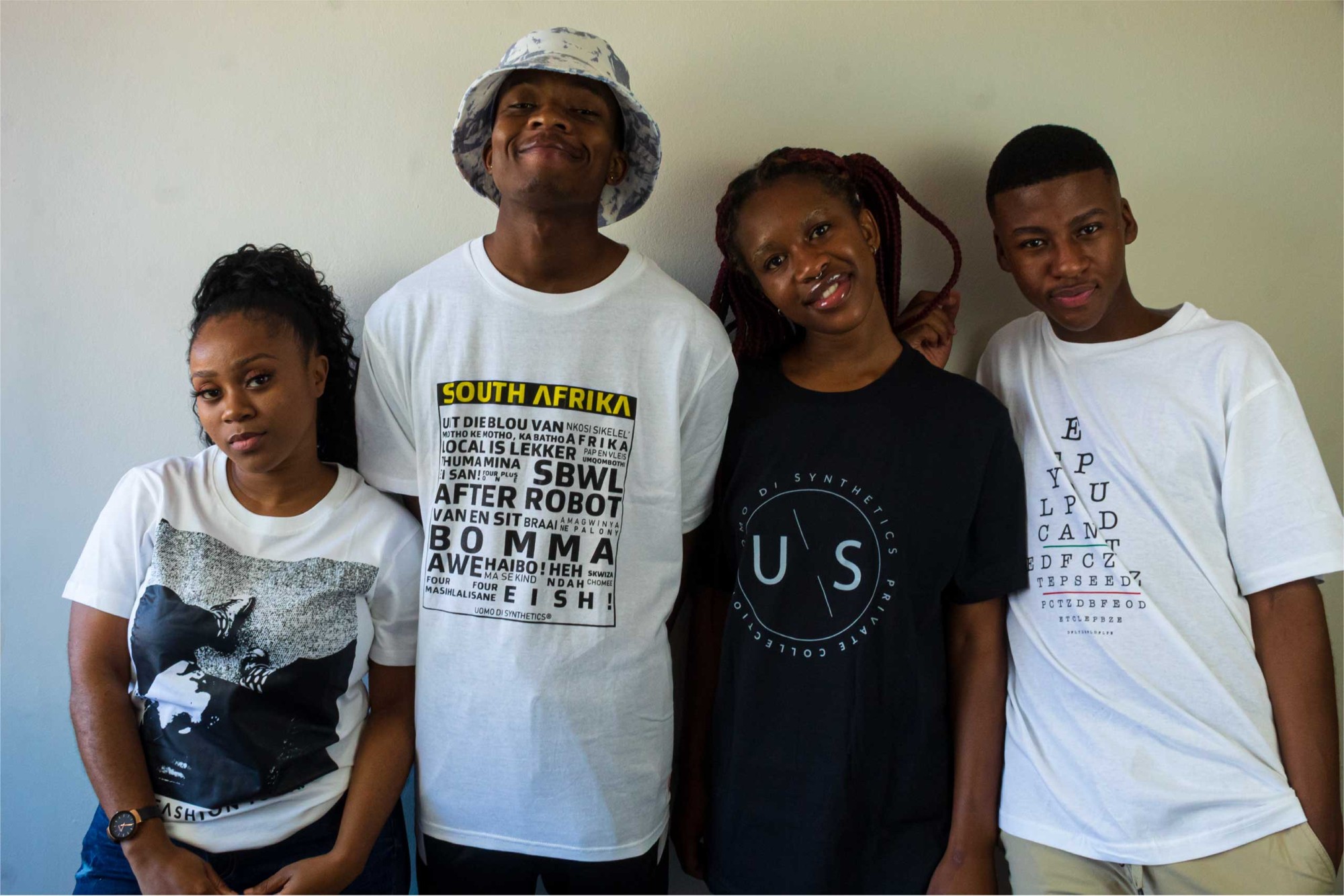 Four models wearing UOMO DI graphic tees from the campaign photoshoot